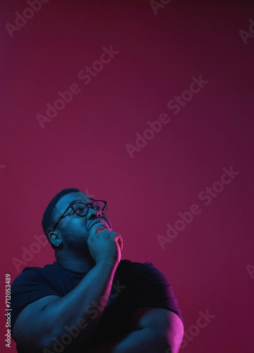 Making decision man. Create plans. Pensive focused thoughtful guy holding chin thinking over new project isolated on dark pink copy space background. © golubovy