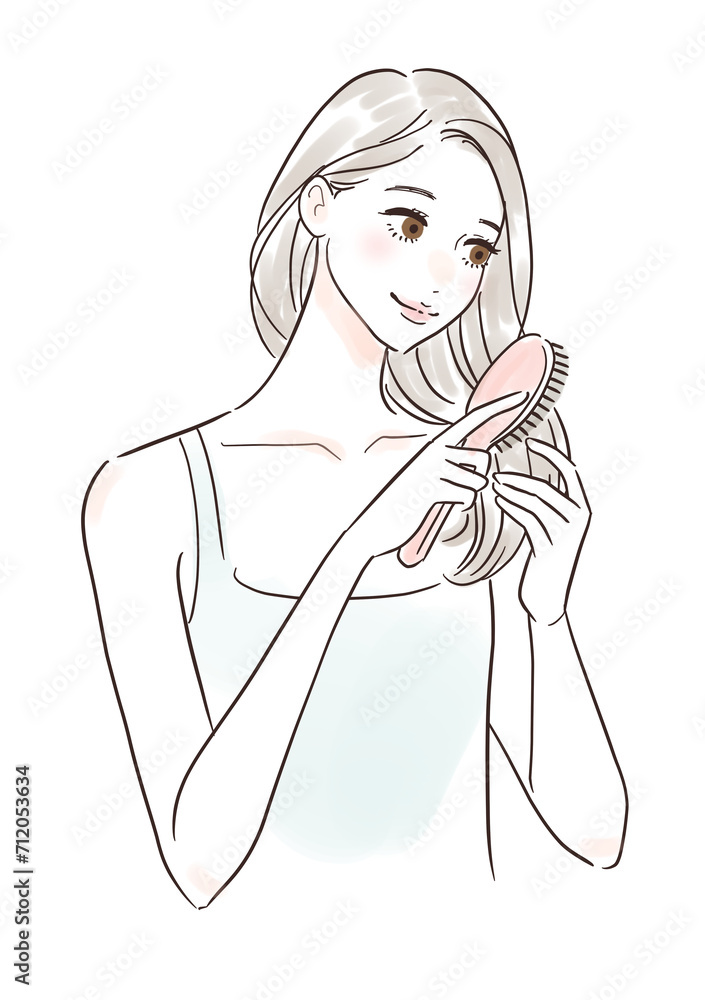 笑顔で髪をブラッシングする女性