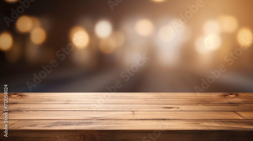 Empty wooden table top with a defocused background of warm glowing lights, ideal for product display or montage.