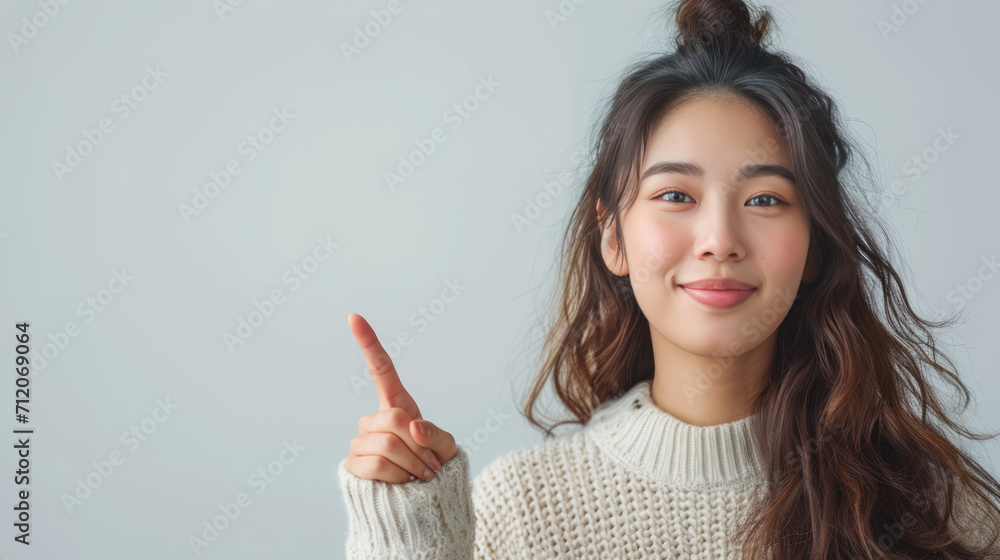 Beautiful Asian women, pointing finger up at copy space isolated on background. Beautiful Asian women, pointing finger up at copy space isolated on background.