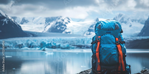 Touristic backpack on blurred astonishing glacier landscape background.