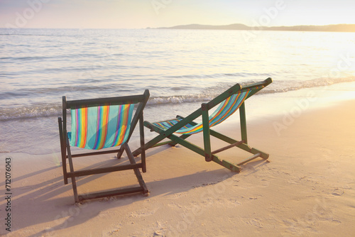 Two sun chairs on the beach © Dasha Petrenko