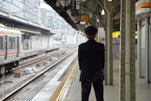 冬の名古屋駅のホームで電車待ちの駅係員の姿 photo