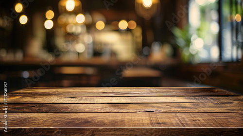 wood table on blur of cafe, coffee shop, bar, background - can used for display or montage your products photo