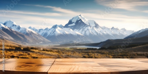 The empty wooden brown table top with blur background of Mount Cook landscape. Exuberant image. generative AI