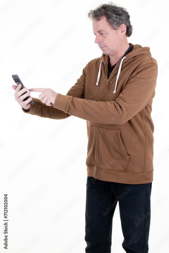 handsome middle aged man text messaging smartphone over mobile phone and standing on white background handsome middle aged man text messaging smartphone over mobile phone and standing on white background