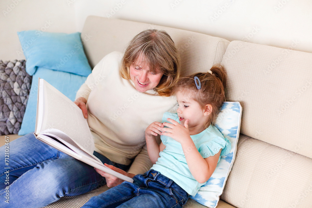 Granny and little girl reading book together Granny and little girl reading book together