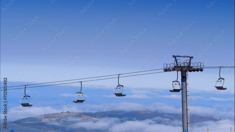 Timelapse. Empty chair lift in high mountain above clouds. Torre mountain peak of Serra da Estrela.The highest place in Continental Portugal.
