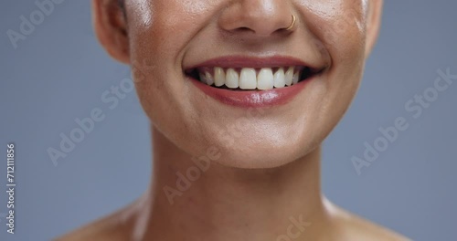 Teeth, mouth and tongue out, woman with beauty or dental, happy for dermatology and orthodontics on grey background. Lick, smile and zoom for oral health, hygiene and wellness with grooming in studio photo