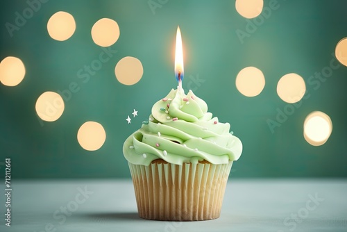 Tasty birthday cupcake with candle on green background Room for text