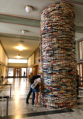 Photography People sticking their heads in a stack of books
