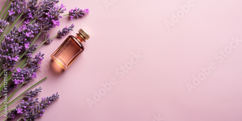 flat lay with a bottle of rose oil and lavender flowers. essential oil