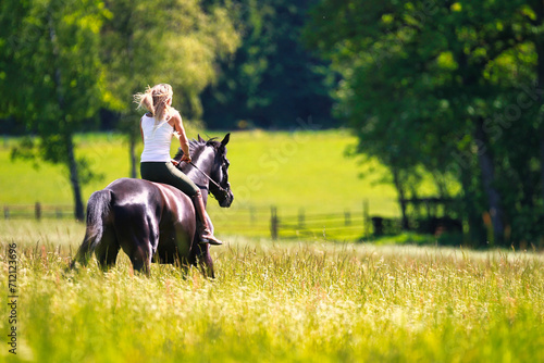 Woman women with horse riding horses on a summer meadow without a saddle. © RD-Fotografie