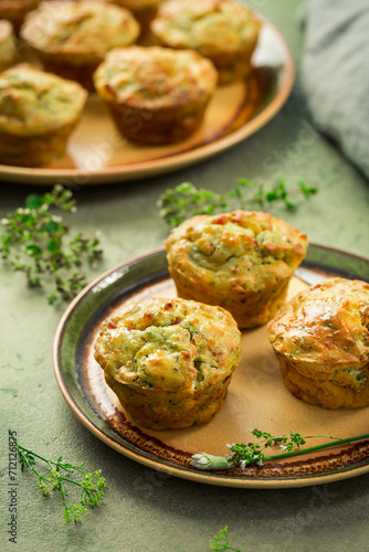 Homemade savory muffins with zucchini and cheese on kitchen table