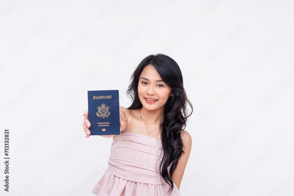 Smiling young woman in a pink dress joyfully presenting her US passport, concept of travel and identity. Smiling young woman in a pink dress joyfully presenting her US passport, concept of travel and identity.