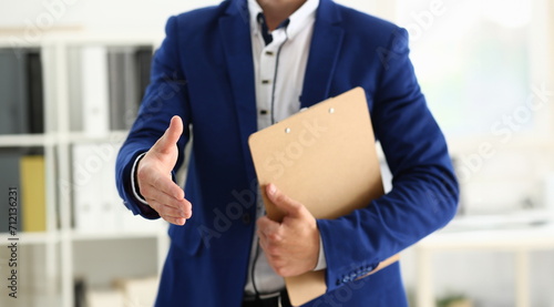 Close-up of businessman willing to shake hand, confirm deal, support decision, finish discussion. Friendly gesture towards client. Deal, agree concept photo