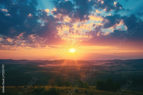 Stylized photo of a sunrise seen from a high vantage point over a rolling countryside