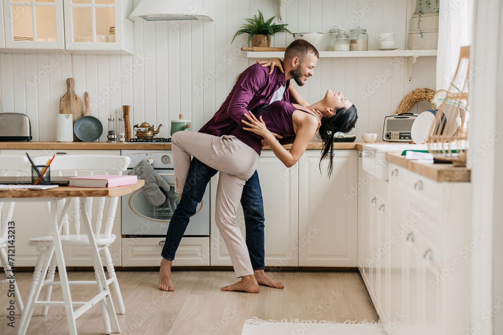 Man lifting woman in a playful dance at home Man lifting woman in a playful dance at home