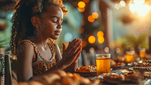 Little beautiful girl prays before eating