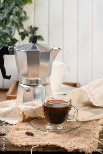 Moka pot with coffee and cup