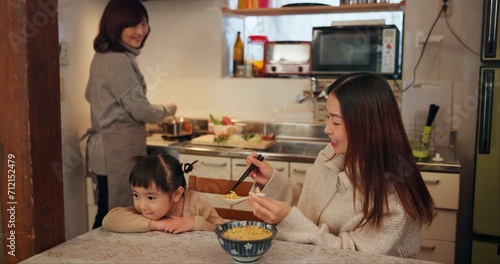 Canvas Print Family, Japanese and mother feeding kid in kitchen of home for growth, health or nutrition