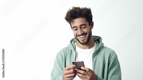 happy Caucasian young man using a smartphone for calls and social media.