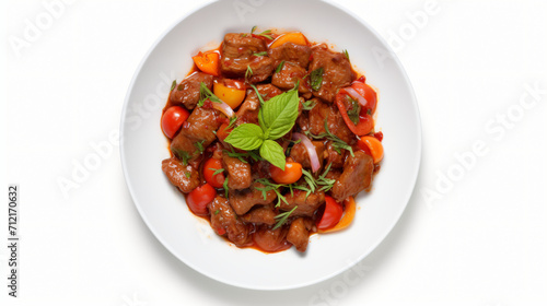 Plate with delicious goulash isolated on white top view