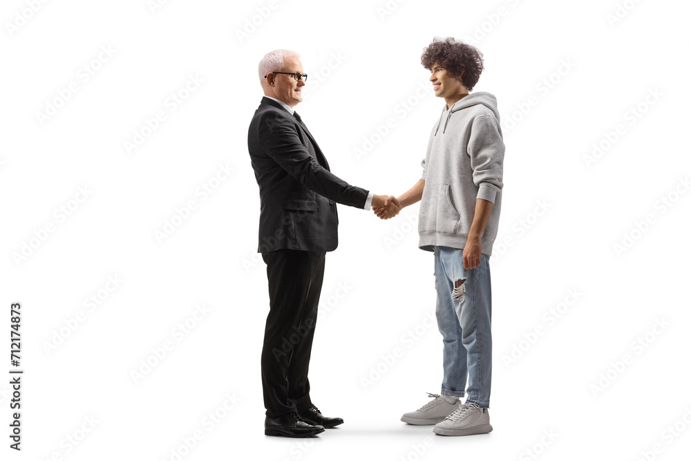 Mature businessman and a generation z guy shaking hand Mature businessman and a generation z guy shaking hand