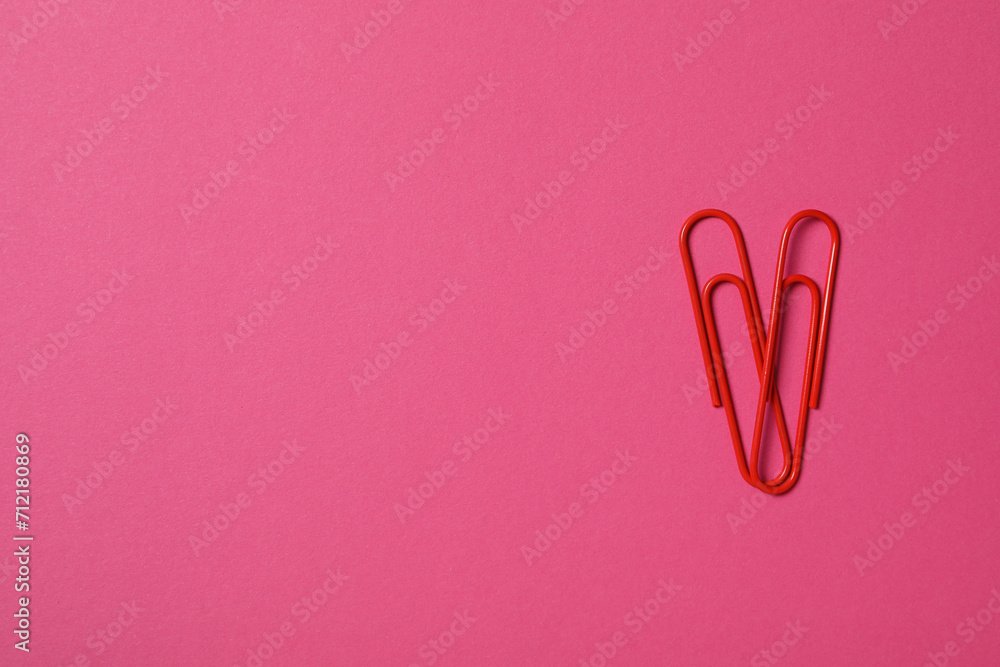 Heart from paper clips, on a red background. Heart from paper clips, on a red background.