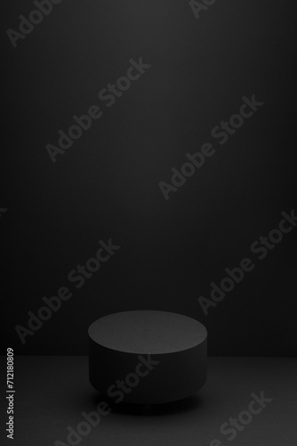 Flying black round podium, mockup on black background with shadow, vertical. Scene template for presentation cosmetic products, gifts, goods, advertising, design, display, showing in minimalist style.