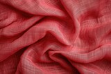 Wrinkled light red linen fabric background with a pure texture
