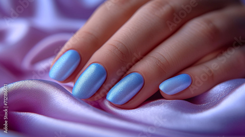 Beautiful blue manicure on a delicate light background
