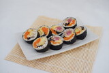 Sushi rolls on a plate on a white background. Japanese food