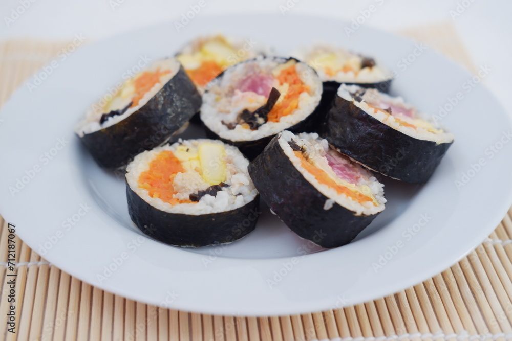 Sushi rolls on a plate on a white background. Japanese food Sushi rolls on a plate on a white background. Japanese food