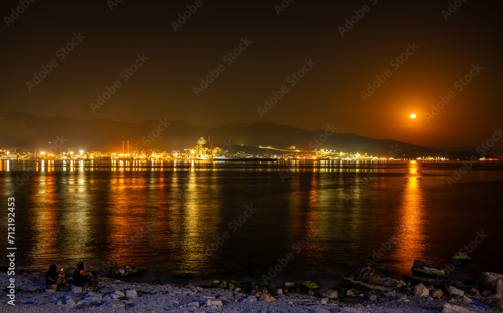 Blurred night background with lights of the sea promenade.