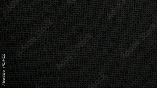 Jute hessian sackcloth canvas woven texture pattern background in light black color blank empty. Black Hemp rope texture background. Haircloth wale black dark cloth wallpaper.  photo