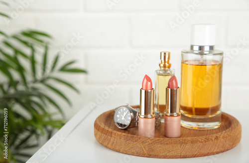 Cosmetic set on light dressing table on light background