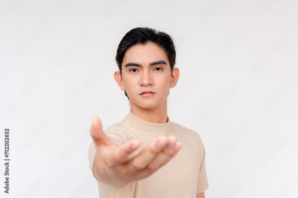 Portrait of a focused young Asian man with an outstretched hand, symbolizing invitation or assistance, isolated on a white background. Portrait of a focused young Asian man with an outstretched hand, symbolizing invitation or assistance, isolated on a white background.
