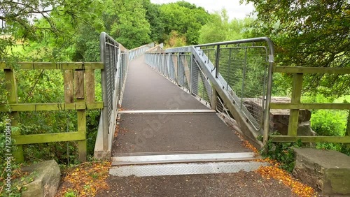 Metal bridge, forest and green trees in Chippenham England, 4K shot photo