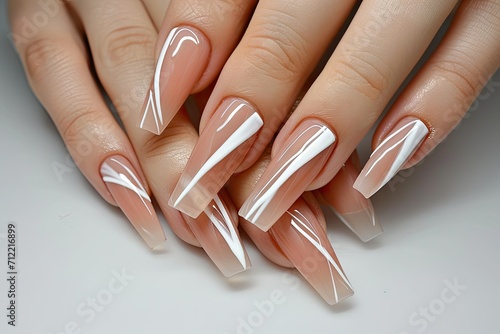 Nail art design featuring long coffin nails nude base shade French tips and white lines photo