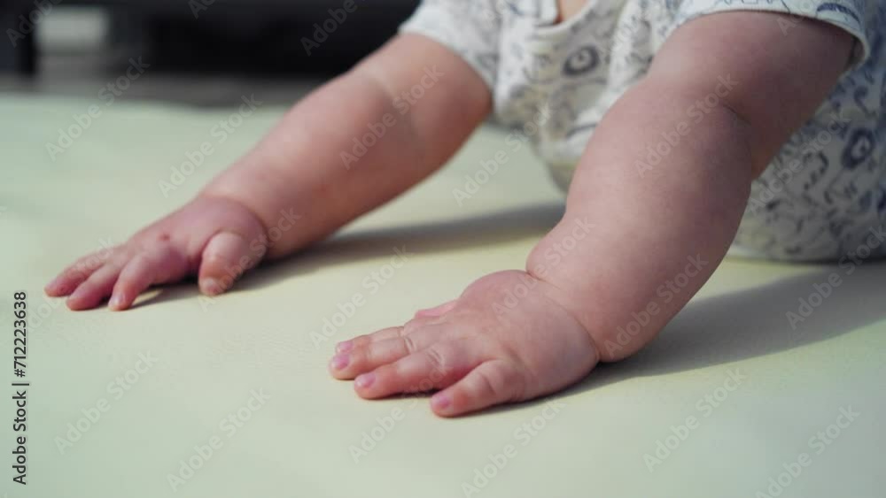 tilting shot from baby's hands to his face while he attempts to learn how to crawl tilting shot from baby's hands to his face while he attempts to learn how to crawl