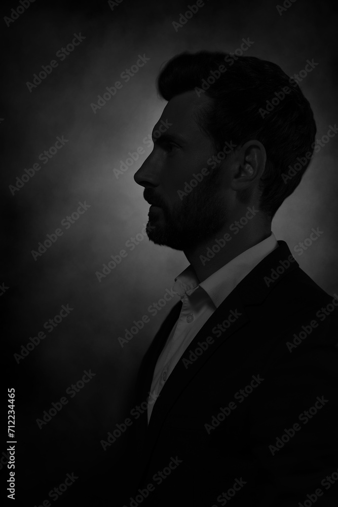 Obraz premium Silhouette of man in darkness. Portrait on black background