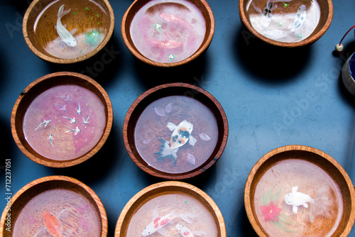 Fishes are painted in wooden bowls
