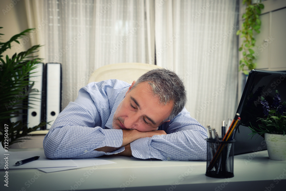 Fototapeta premium Detail of a man sleeping on an office table
