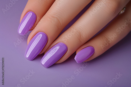 Beautiful purple nails on a purple background  nail design close-up
