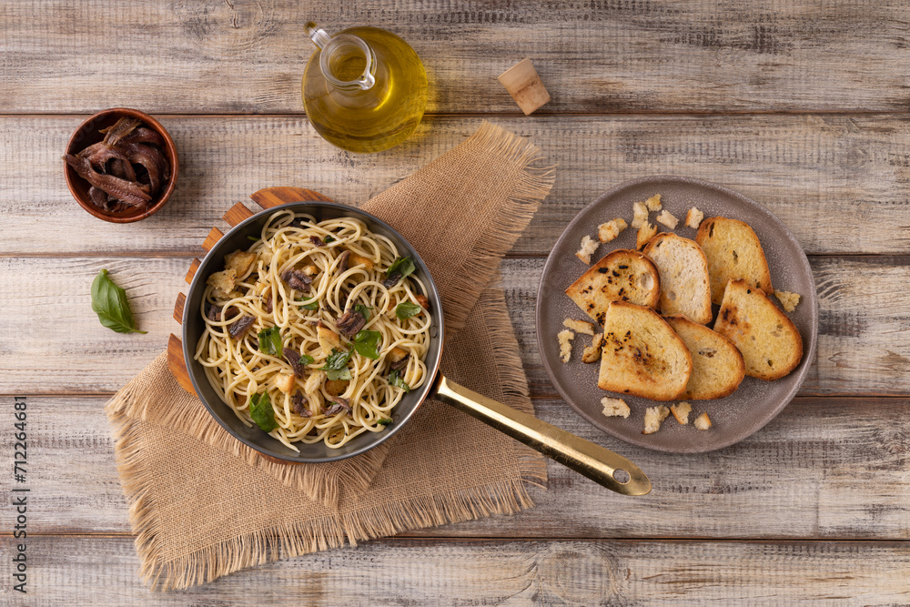 Classic spaghetti with anchovies served with croutons. Classic spaghetti with anchovies served with croutons.