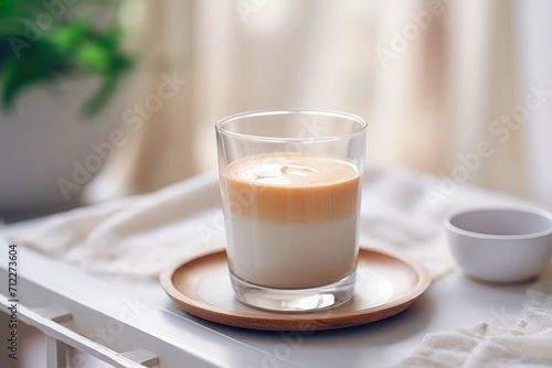 Creamy latte in a clear glass on the table
