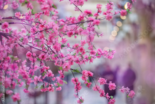 Artificial sakura branches as a design element on a pink background.