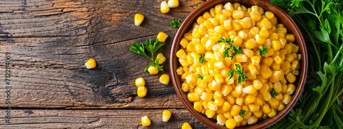 tasty corn in a plate on a wooden background photo
