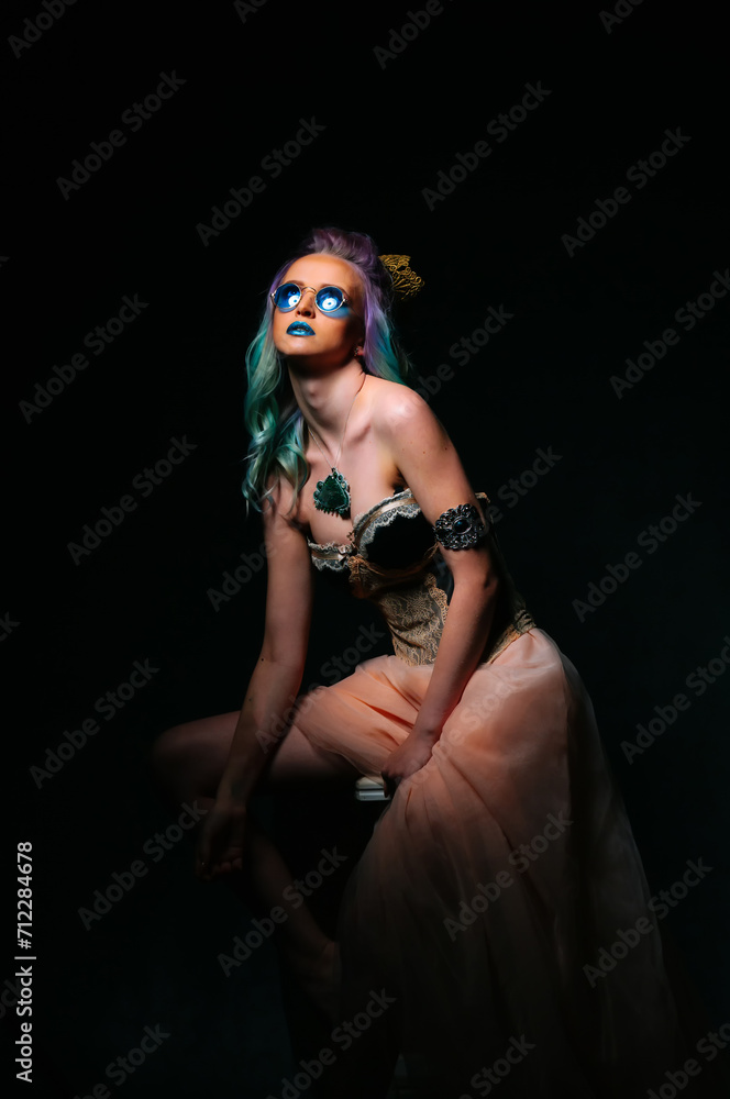 Woman With Green Hair and Blue Eyes Sitting on Chair Woman With Green Hair and Blue Eyes Sitting on Chair
